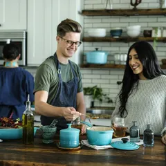 A bright home kitchen with open shelving and colorful cookware